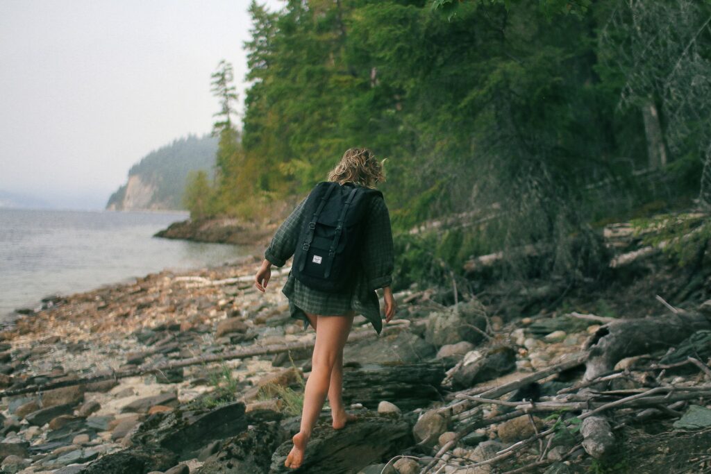woman walking on rocky seashore