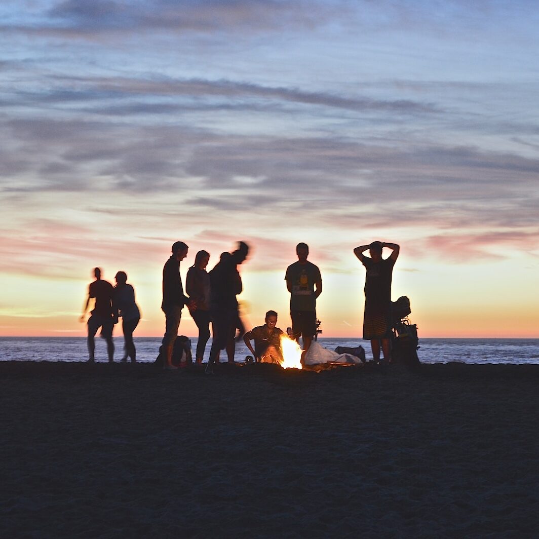 group of people setting up campfire