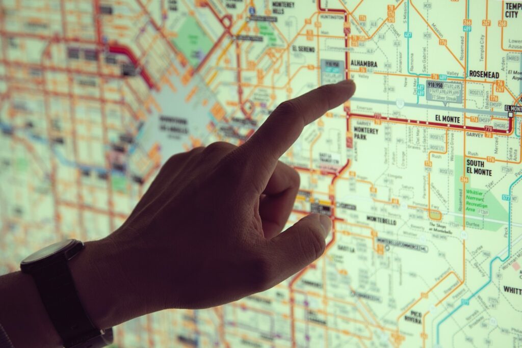 a person pointing to a spot on a map